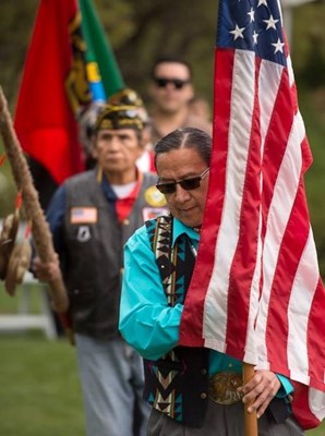 Ground Blessing Ceremony photo of man with flag.jpg