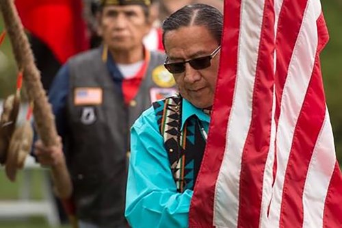 Ground Blessing Ceremony photo of man with flag web.jpg